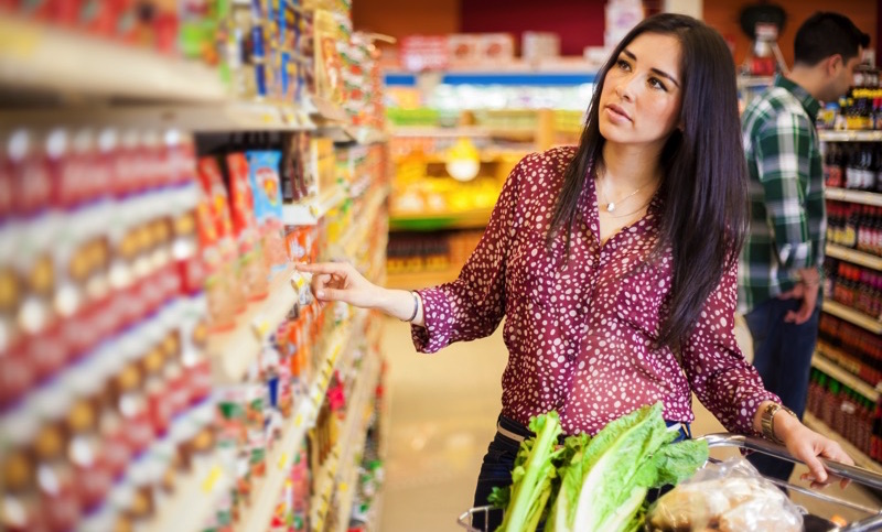 woman looking at food at the supermarket