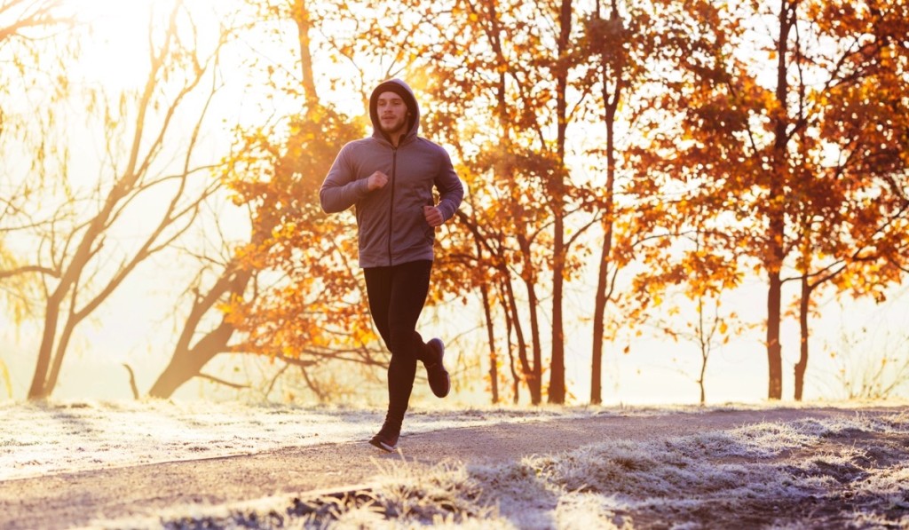 Hombre con ropa deportiva corriendo en un parque 